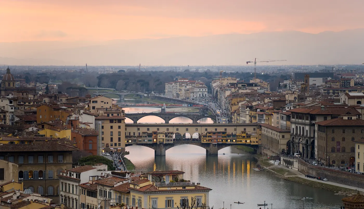 The rooftops of Florence and the Ponte Vecchio over the Arno at dusk, seen from Piazzale Michelangelo